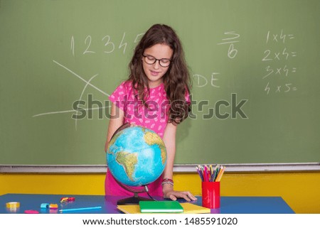Schoolgirl reading the world globe