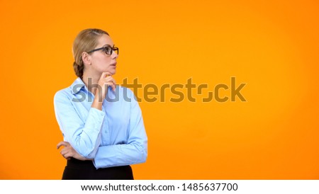 Thoughtful business lady making choice on bright background, taking decision