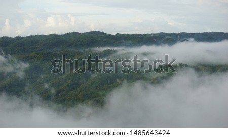 white clouds in the mountains with the atmosphere in the morning