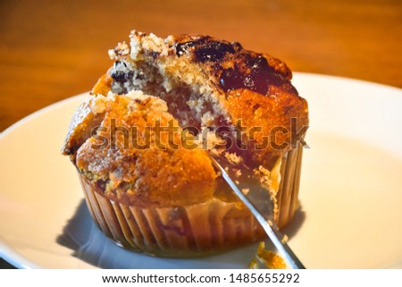 Banana cupcakes topped with delicious chocolate chips  Place in a white ceramic dish on a wooden table background.