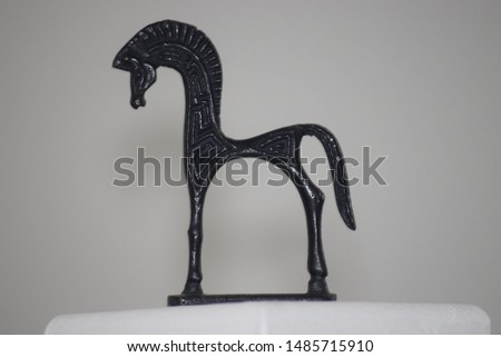 Close up shot of a horse figure. Look like Greek style symbol.