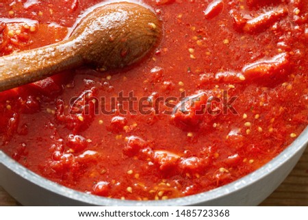 Cooking tomato sauce in a large pan Royalty-Free Stock Photo #1485723368