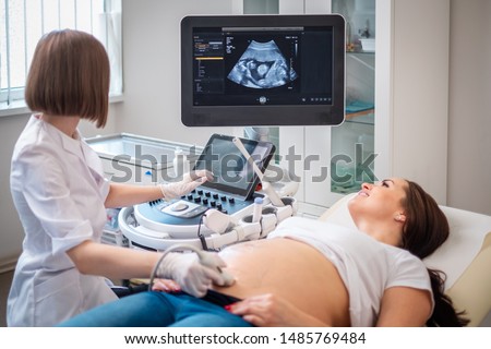 Pregnant woman on utltrasonographic examination at hospital Royalty-Free Stock Photo #1485769484