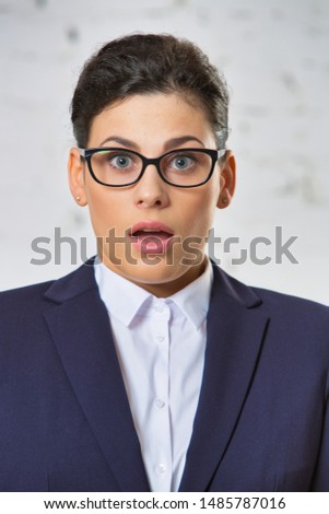 Portrait of shocked businesswoman wearing eyeglasses