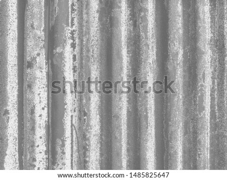 Old rusty corrugated metal sheet with various textures due to exposing to changing weather and acidic rain.