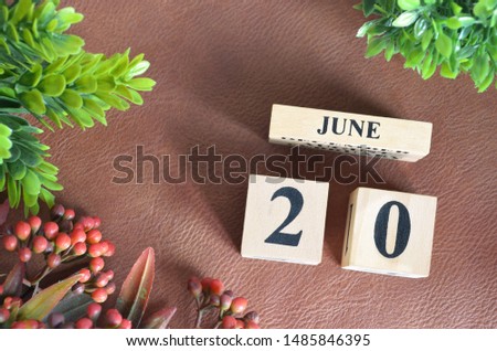 June 20. Number cube in natural concept on leather for the background