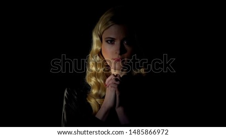 Female sinner praying in dark room, looking for forgiveness, faith and belief