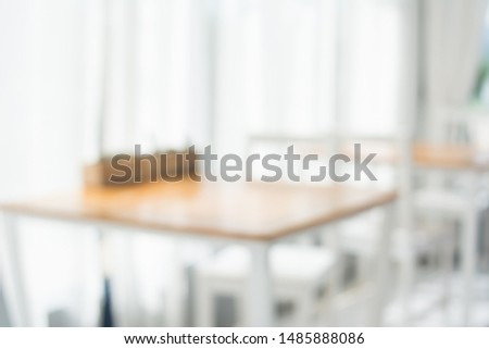 Blurred work room with brown desk and white chair