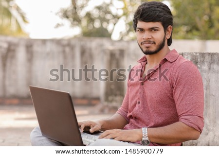 Young man working in laptop at outdoor.