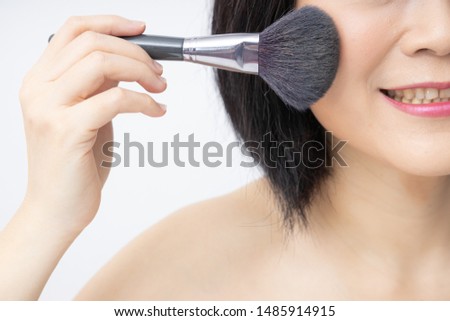 Blush cheek makeup. Portrait beautiful Asian woman holding a blush brush. Own make up Cosmetology Beauty skin care Professional women Taking care of yourself and advertising concept. Close up