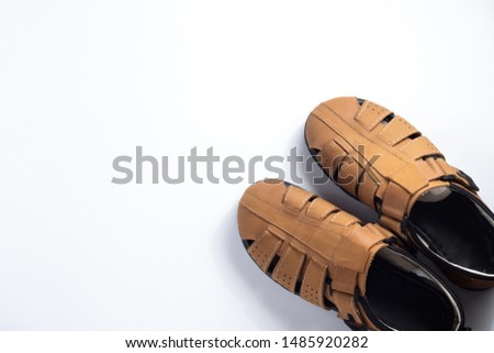 Top view men's leather brown sandals with copy space. Shoe store fashion store, style concept. Banner for modern and fashionable shoe store