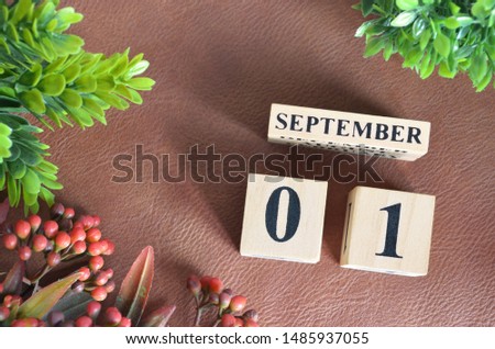 September 1. Number cube in natural concept on leather for the background