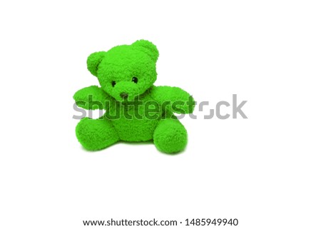 a green bear doll sitting on white background isolated