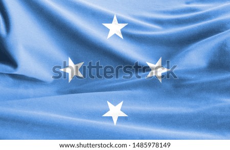 Realistic flag of Micronesia on the wavy surface of fabric