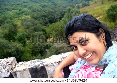 a beautiful girl is enjoying nature in a hill station