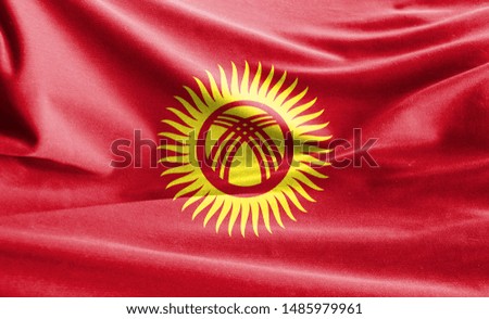 Realistic flag of Kyrgyzstan on the wavy surface of fabric