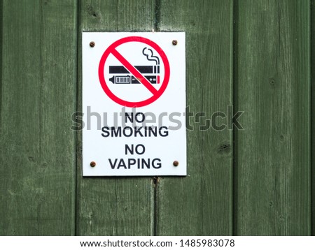 No Smoking No Vaping sign on a wooden door