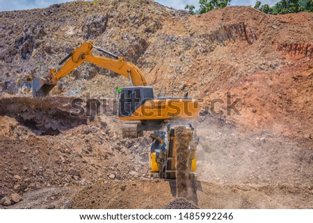 Highway construction site with heavy duty machinery.