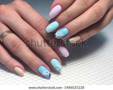 Trendy blue manicure with pink foil. Mirror glitter on a textured background.