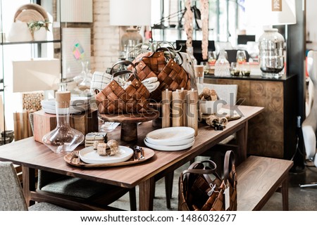 wooden table with modern home goods, unique home decoration store Royalty-Free Stock Photo #1486032677
