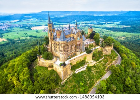 Hohenzollern palace on mountain top in Stuttgart vicinity, Germany, Europe. Aerial view of old castle, landmark of Swabian Alps. Landscape panorama, skyline. Sightseeing and travel in Stuttgart.
