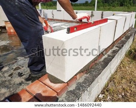 Start of construction in a new building with a free plan of red brick and gas-silicate blocks.