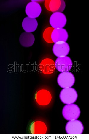 Festive background with blurred red and purple lights. Contrast color illumination wallpaper. Vertical format backdrop. Overlay for photos and graphic design projects. Holiday celebration mood