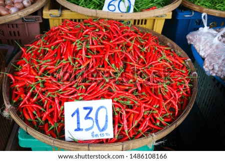 Fresh red hot chilies in a basket sold at local market at Thailand