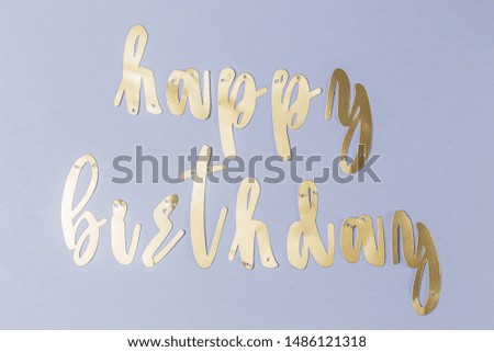 Happy Birthday golden sign in a blue surface