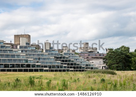 Campus of the University of East Anglia as seen from Earlham Park and lake in the outskirts of Norwich on a cloudy day, England. Royalty-Free Stock Photo #1486126910