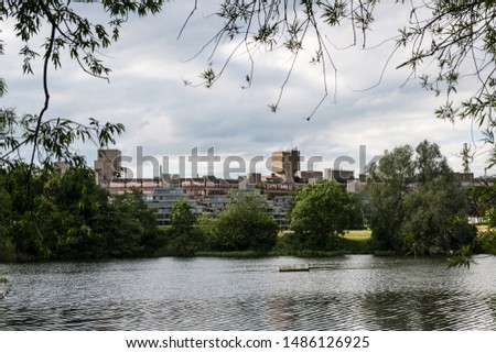 Campus of the University of East Anglia as seen from Earlham Park and lake in the outskirts of Norwich on a cloudy day, England. Royalty-Free Stock Photo #1486126925