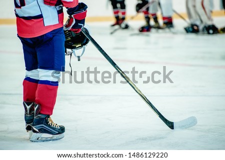 hockey player and stick in the ice arena at shallow depth of field