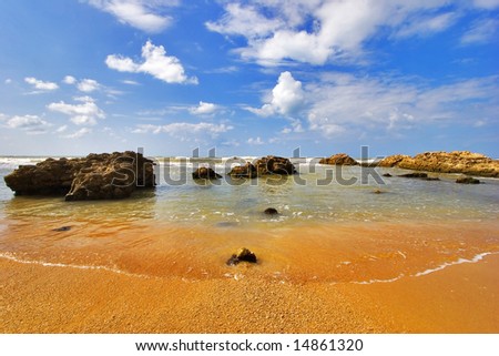 Coast of Mediterranean sea with big stones in water