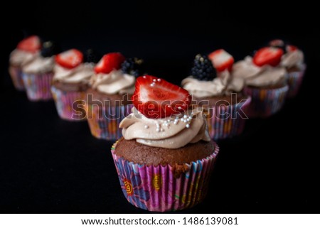 chocolate cupcakes with strawberry and blackberry