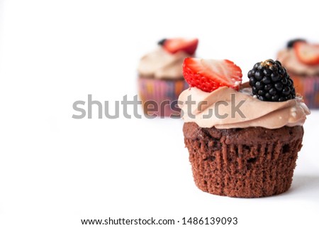 chocolate cupcakes with strawberry and blackberry