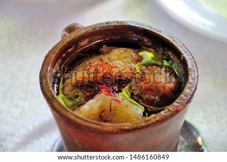 Azerbaijani Sheki piti soup prepared with mutton, tail fat, chickpeas, potato, onions, dried alycha and saffron and cooked in a clay pot  Royalty-Free Stock Photo #1486160849