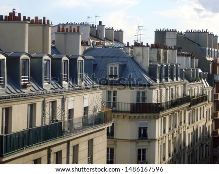 Typical houses with roofs, balconies, and chimneys, Paris, France, April 2016