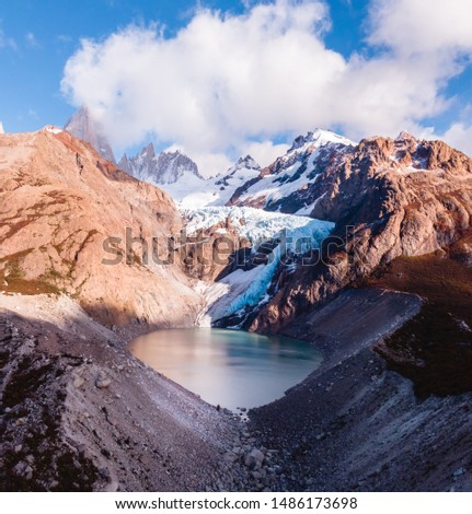 Drone View of Cerro Torre ice glacier mirador valley and snowcapped peaks. Laguna Torre hiking trek. Mountains, nature, travel. Blue sky. Shot in El Chalten, Mount Fitzroy, Patagonia, Argentina