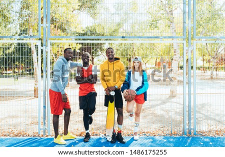Portrait of multiethnic teenager group looking at camera at the basketball court