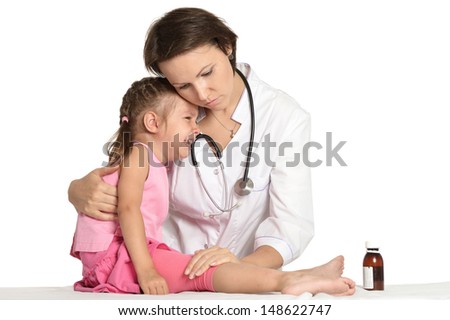 female pediatrician with a little patient on a light background