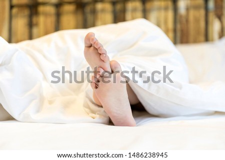 Children's feet in white bedding