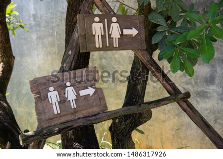 Toilet sign on the tree