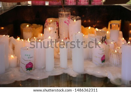 a candlelit prayer  (kor : in the arms of the Buddha)