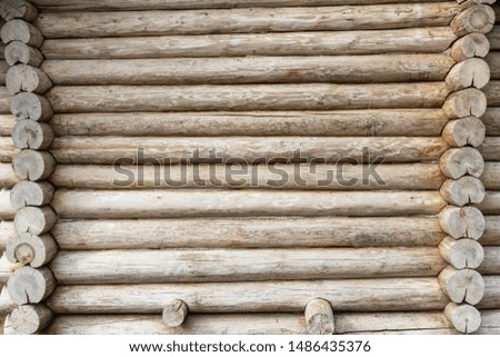 Old house made of logs. Larch wooden texture. Details of connection of corners.  Ancient architecture. Space for text.
