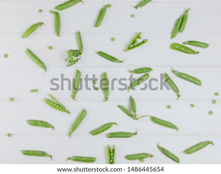 Food photography. Peas scattered on a white board