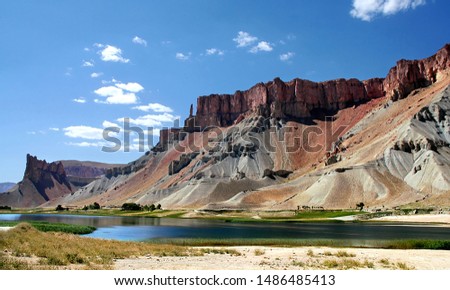 Band-e Amir lakes near Bamyan (Bamiyan) in Central Afghanistan. Band e Amir was the first national park in Afghanistan. View of the red Hindu Kush mountains near Band e Amir lakes in Afghanistan. Royalty-Free Stock Photo #1486485413