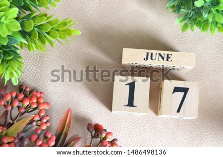 June 17. Number cube in natural concept on white leather for the background