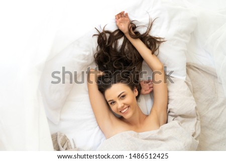 Beautiful smiling lady resting in bedroom at home stock photo