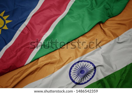 waving colorful flag of india and national flag of namibia. macro