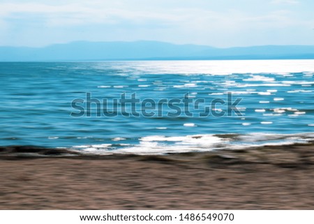 Abstract view of seascape with sunlight reflected in the water. Intentional camera movement (ICM)